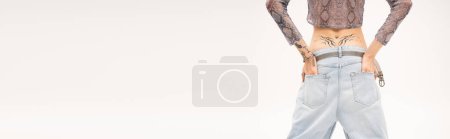 Cropped view of nonbinary person holding hands in pockets isolated on white, banner 