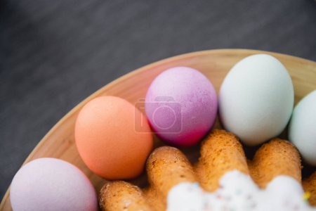 Top view of colorful Easter eggs and tasty homemade cake on table 