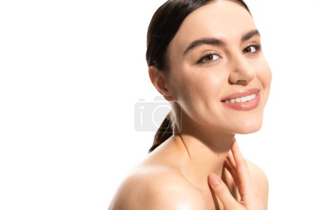 satisfied young woman with bare shoulders looking at camera isolated on white 
