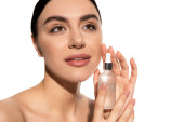 dreamy woman with bare shoulders holding bottle with moisturizing serum isolated on white  Longsleeve T-shirt #642937186