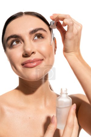 cheerful and brunette woman holding dropped with serum isolated on white  mug #642937448