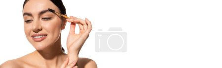 Foto de Feliz joven mujer peinado cejas con gel aislado en blanco, bandera - Imagen libre de derechos