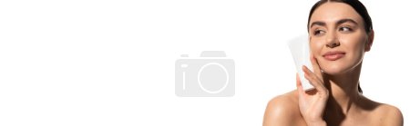 happy young woman with bare shoulders holding tube with body lotion isolated on white, banner 