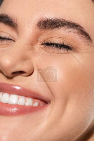 close up of positive young woman with flawless and natural makeup 