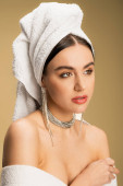 young woman in luxurious jewelry posing with towel on head on beige  puzzle #642941290