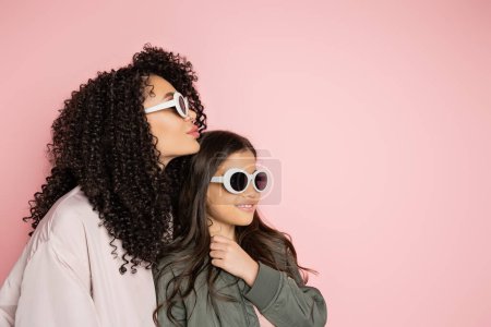Photo for Trendy parent and child in sunglasses standing isolated on pink - Royalty Free Image