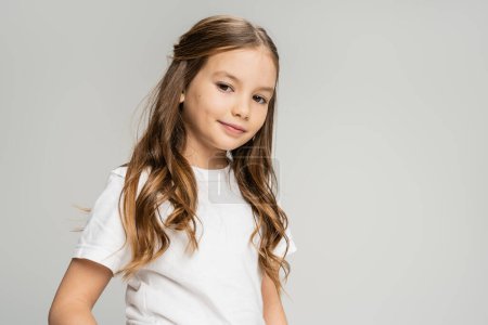 Photo for Preteen child in white t-shirt looking at camera isolated on grey - Royalty Free Image