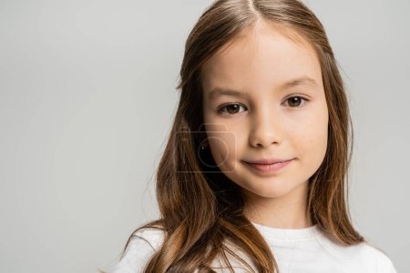 Photo for Portrait of preteen girl in white t-shirt looking at camera isolated on grey - Royalty Free Image