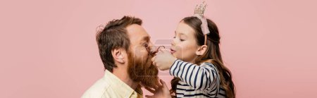 Child with crown headband curling eyelashes of father isolated on pink, banner 