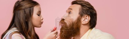 Photo for Preteen girl holding lipstick near bearded father isolated on pink, banner - Royalty Free Image
