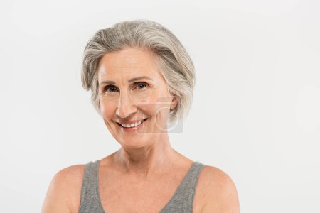 Photo for Portrait of happy senior woman smiling and looking at camera isolated on grey - Royalty Free Image