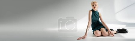 Photo for Full length of albino woman in tight dress and boots posing on grey background with shadows, banner - Royalty Free Image