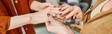 cropped view of mother touching hand of engaged son with wedding ring, banner