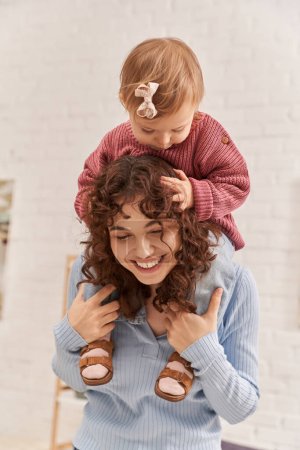 Photo for Smiling woman with baby girl on shoulders, balanced lifestyle, mom daughter time, having fun together, quality time, work and life harmony, loving motherhood, happiness - Royalty Free Image