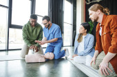 medical instructor explaining african american man cardiopulmonary resuscitation techniques near CPR manikin and young multiethnic team, life-saving skills and emergency preparedness concept Mouse Pad 661886354