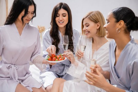 strawberries and champagne, four women, bridal party, interracial girlfriends having fun, brunette and blonde, bride and her bridesmaids spending time together, cultural diversity, bedroom 