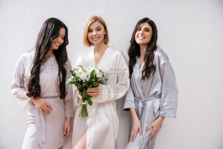Photo for Happy bride with white flowers, cheerful and diverse bridesmaids, bridal bouquet, cultural diversity, friendship goals, brunette and blonde women, bridal shower, smile and joy - Royalty Free Image