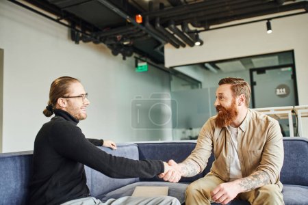 pleased business partners shaking hands and smiling at each other while confirming agreement in lounge of modern office environment, partnership and success concept puzzle 663845658