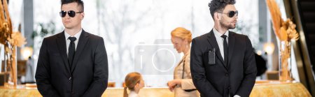personal security, handsome bodyguards in suits and sunglasses protecting mother and child in hotel lobby, luxury lifestyle, woman and girl standing at reception desk, banner