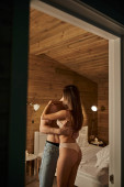 passionate man hugging woman in underwear, vacation house, bedroom, sexy couple, love and romance Poster #666375314