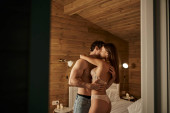 passionate man hugging sexy woman in underwear, vacation house, couple in love, lovers in bedroom Longsleeve T-shirt #666375422