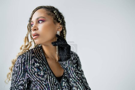 fashion and accessories, african american woman in blouse looking away on grey background, portrait