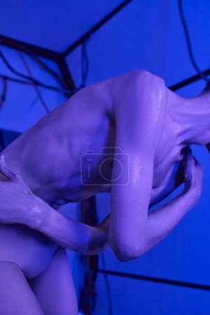 Photo for Futuristic science concept, cropped view of cosmic traveler, alien in neon light of innovation hub - Royalty Free Image