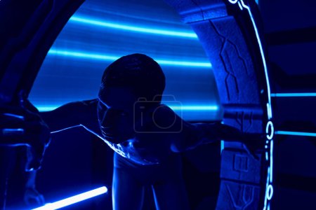 Photo for Cosmic visitor, unidentified otherworldly humanoid near innovative equipment in discovery lab - Royalty Free Image