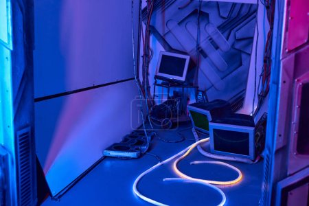 Concept futuriste, moniteurs d'ordinateur et fils dans un hub d'innovation néon