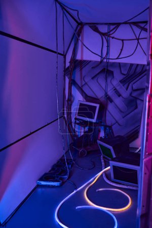 scientific invention, computers, monitors and wires in futuristic discovery center, neon light
