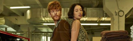 Photo for Fashionable young multiethnic couple standing back to back in public laundry, banner - Royalty Free Image