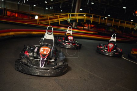 modern racing cars inside of indoor kart circuit, motor race vehicles, speed racing karting