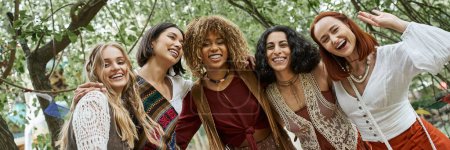 Photo for Cheerful interracial women in boho styled clothes looking at camera in retreat center, banner - Royalty Free Image