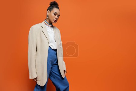 stylish fashion model with vivid colourful makeup and accessories posing and looking at camera