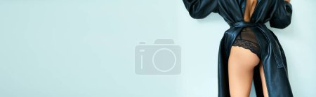 Photo for Cropped sexy woman in leather coat with open back and lace panties standing near grey wall, banner - Royalty Free Image