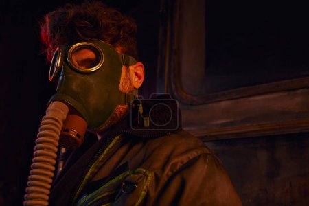 Photo for Nuclear catastrophe survivor wearing  gas mask in abandoned subway, post-apocalyptic, game character - Royalty Free Image