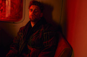 exhausted man sitting pin red light of dirty carriage of post-apocalyptic subway, game character Longsleeve T-shirt #675365446