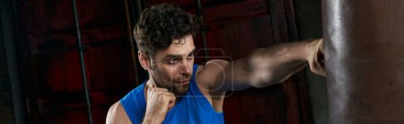 self-confident unshaven man boxing punching bag in darkness of city, street sport, banner