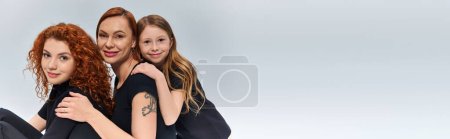 Photo for Three generations concept, happy redhead family looking at camera on grey backdrop, banner - Royalty Free Image