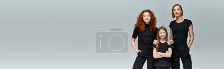 three generations of stylish women in matching clothes standing on grey background, banner magic mug #675862398