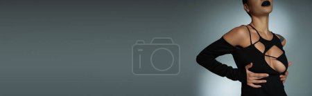 Photo for Cropped view of stylish seductive woman in black halloween costume on grey, gothic beauty, banner - Royalty Free Image