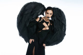 sinister beauty, woman in costume of fallen angel with black wings looking at camera on white Longsleeve T-shirt #676127986