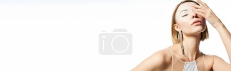 Photo for Magic charm, woman with angelic face and enchanting makeup obscuring face with hand on white, banner - Royalty Free Image