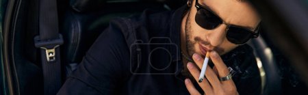good looking man with ponytail smoking cigarette behind steering wheel, fashion concept, banner