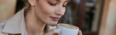 banner of beautiful blonde woman in trench coat enjoying her cup of cappuccino in cafe