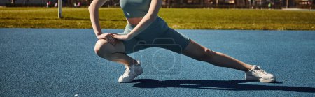 cropped sportswoman with ponytail exercising in activewear outdoors, woman doing lunges, banner