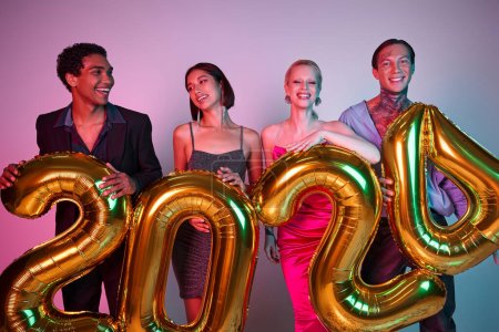 Happy New Year, joyful interracial friends in festive attire holding balloons with 2024 numbers
