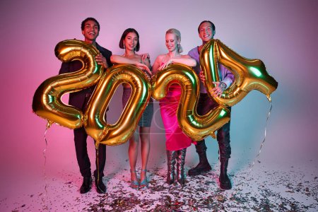 New Year party, joyful interracial friends in festive attire holding balloons with 2024 numbers