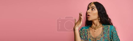 Photo for Shocked attractive indian woman in traditional blue sari posing with hand near mouth, banner - Royalty Free Image