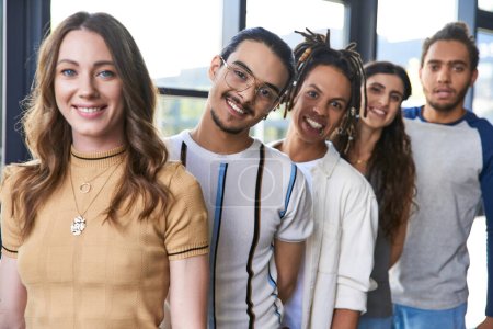 group portrait of diverse multiethnic team in stylish casual attire smiling at camera in office